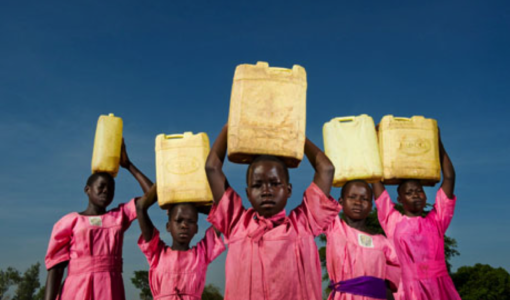 Ugandan children carrying water